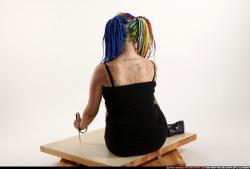 dolores-sitting-pistol-knife-pose