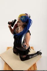 dolores-kneeling-pistol-shotgun