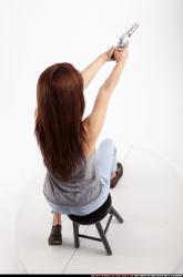 molly-sitting-aiming-pistol