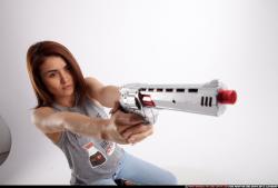 molly-sitting-aiming-pistol