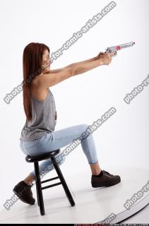 molly-sitting-aiming-pistol
