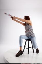molly-sitting-aiming-pistol