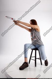molly-sitting-aiming-pistol