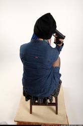 dolores-sitting-pistol-pose