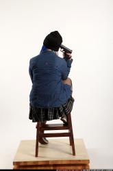 dolores-sitting-pistol-pose