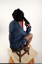 dolores-sitting-pistol-pose