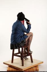 dolores-sitting-pistol-pose