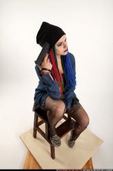 dolores-sitting-pistol-pose