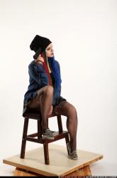 dolores-sitting-pistol-pose