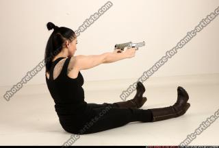 claudia-sitting-dual-pistols