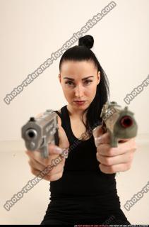 claudia-sitting-dual-pistols