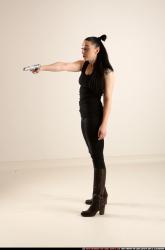 claudia-standing-threatening-pistol