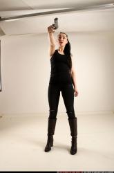 claudia-standing-threatening-pistol