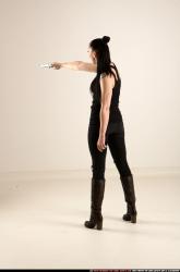 claudia-standing-threatening-pistol