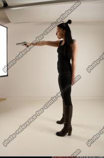 claudia-standing-threatening-pistol