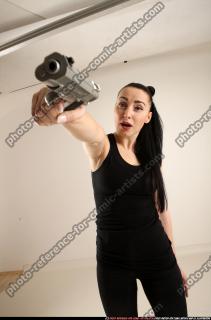 claudia-standing-threatening-pistol