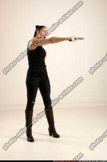 claudia-standing-threatening-pistol