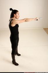 claudia-standing-threatening-pistol