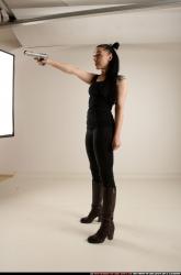 claudia-standing-threatening-pistol