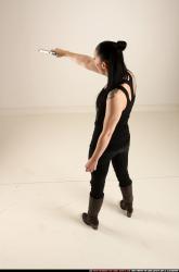 claudia-standing-threatening-pistol