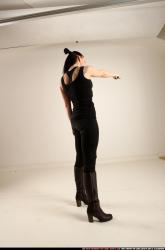 claudia-standing-threatening-pistol