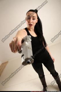 claudia-standing-threatening-pistol