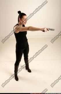 claudia-standing-threatening-pistol