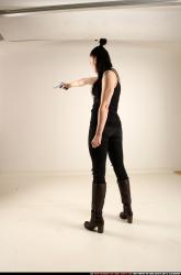 claudia-standing-threatening-pistol