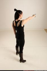 claudia-standing-threatening-pistol