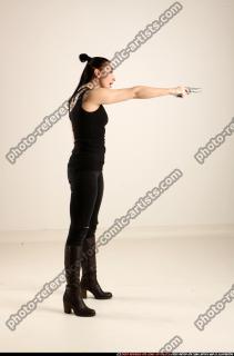 claudia-standing-threatening-pistol