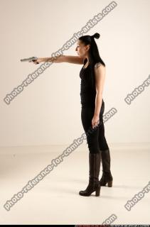 claudia-standing-threatening-pistol