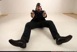 Man Old Average White Fighting with gun Sitting poses Casual