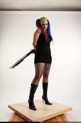 dolores-uzi-shotgun-crossed-behind-back