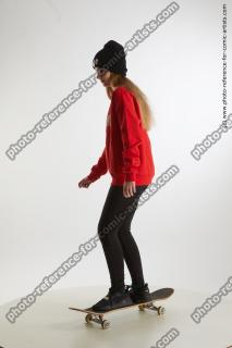 Teenage girl Selin standing on skateboard