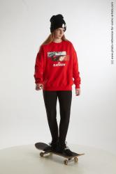 Teenage girl Selin standing on skateboard